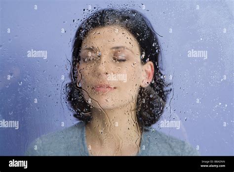A Woman Behind Wet Glass Stock Photo Alamy