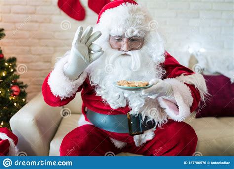 Santa Claus Loves To Eat His Cookies At Home In Christmastime Stock