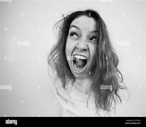 Close Up Portrait Of Insane Woman In Straitjacket On White Background
