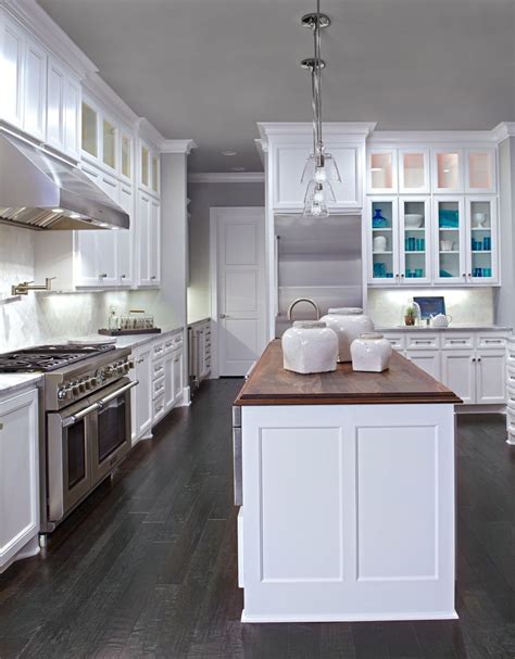 Golden cherry kitchen to create balance. White cabinets, dark wood floors, wood countertop in ...