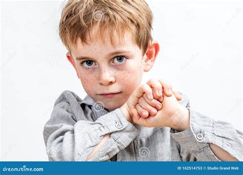 Smiling Child With Blue Eyes Looking Determined Holding His Fists