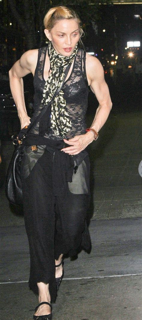 madonna shows off her muscular body in a sheer vest while revealing her maternal side as she