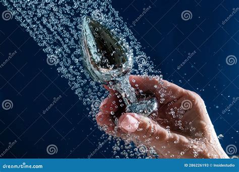 woman washing silver anal plug under shower on blue background stock image image of ecstasy