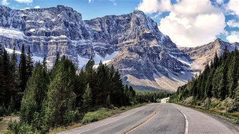 Highway Along A Beautiful Mountain Range Wallpaper