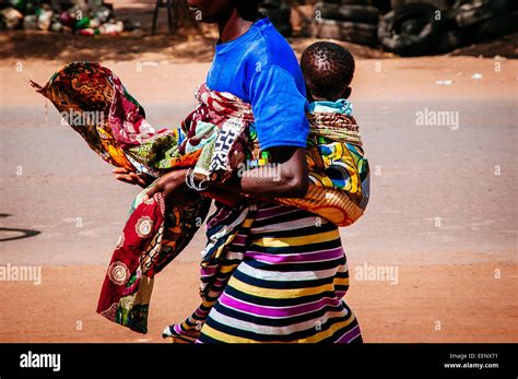 Woman Walking While Carrying Baby On Back Burkina Faso Stock Photo Alamy