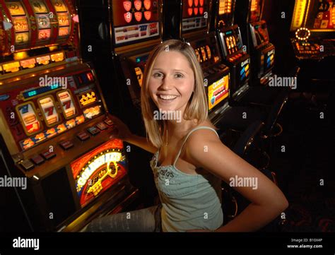 Woman Playing A Slot Machine Stock Photo Alamy