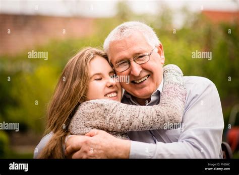 Authentic Photo Of Smiling Grandfather Hugging With His Teenage