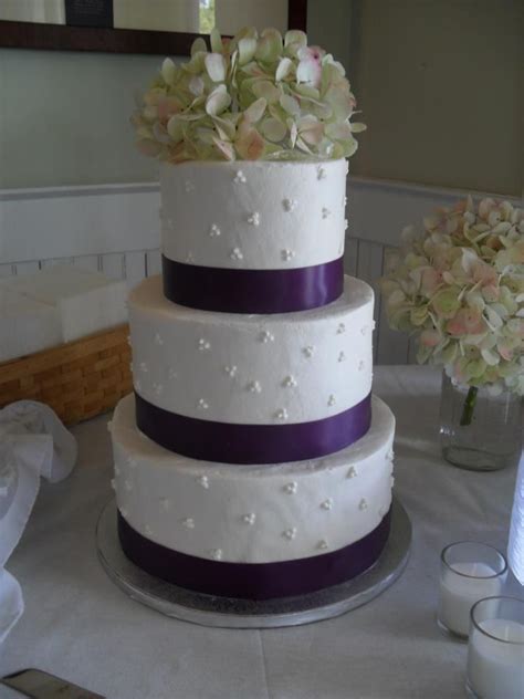 Three Tier Round Wedding Cake With Fresh Hydrangeas And Purple Ribbon