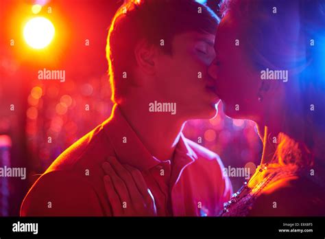 romantic couple kissing on dance floor in nightclub photo stock alamy