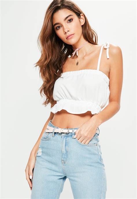 Crop It Like It S Hot This Cami Features A Fresh White Hue Tie Straps A Frill Hem And A