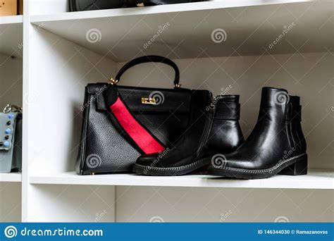 Pair Of Black Leather Shoes With Low Heels And A Black Bag