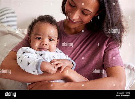 Close Up Of Mixed Race Young Young Adult Mother Holding Her Baby Boy In