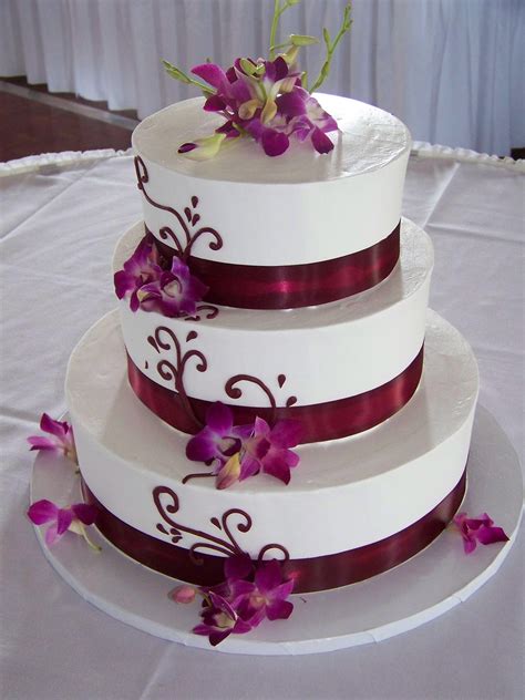 Center a cake board the same size as the tier above it on base tier and press it gently into icing to imprint an outline. Wedding Cake with Dendrobium Orchids | Mitchells Flowers ...