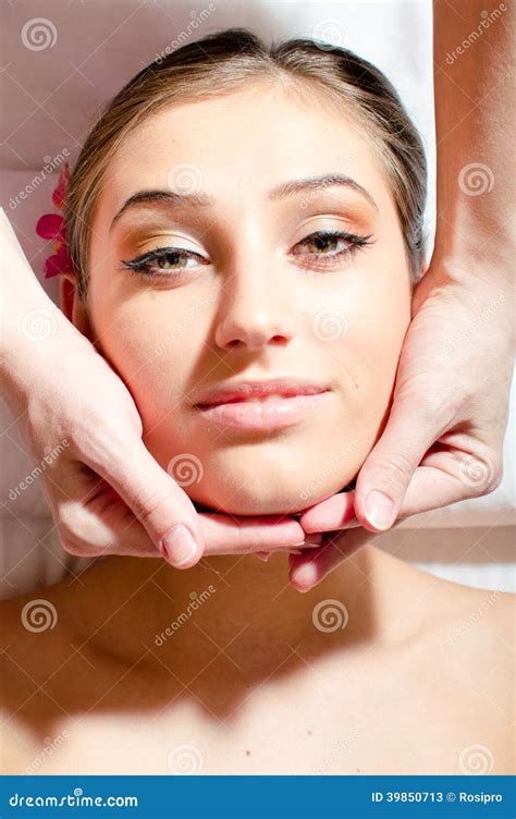 Closeup On Beautiful Nice Young Woman On Spa Treatments During Face Massage Relaxing And Looking
