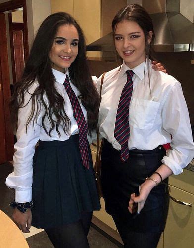 Two Girls Dressed In Formal School Uniforms With White Shirts And Ties