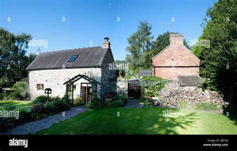 An Old Stone Cottage With A Garden In A Village Stock Photo Alamy