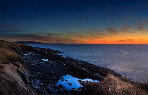 The Rugged Coastline Of Cape Breton Nova Scotia Just After Sunset
