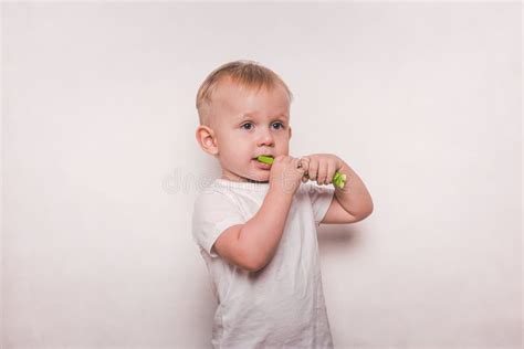 Boy In White Brushing His Teeth With A Toothbrush Stock Image Image