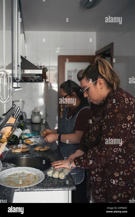 Senior Mother Teaching Her Daughter How To Cook Stock Photo Alamy