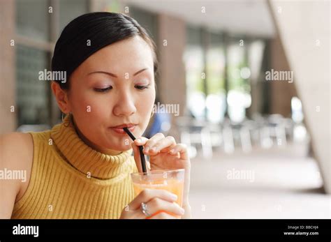Woman Drinking From Straw Stock Photo Alamy