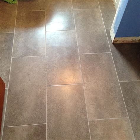 The grey grout is then bleeding into it slightly and looking a bit messy on the cut tiles. Vinyl flooring w Delorean Grey grout (With images) | Vinyl flooring, Flooring, Grey grout