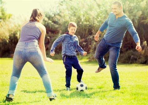 Son And Parents Playing Football Stock Photo Image Of Playing Game