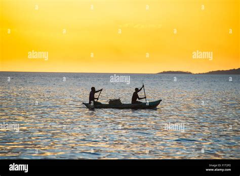 Backlight Of Fishermen In A Little Fishing Boat At Sunset Lake Malawi