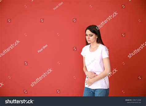 Young Woman Suffering Abdominal Pain On Stock Photo 1384712408