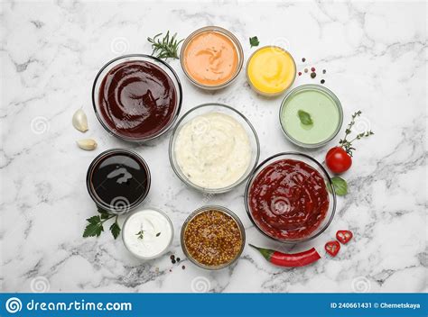 Many Different Sauces And Herbs On White Marble Table Stock Image