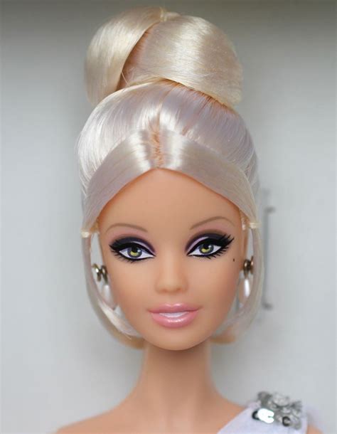 A Barbie Doll With Blonde Hair Wearing A White Dress And Pearls On Its