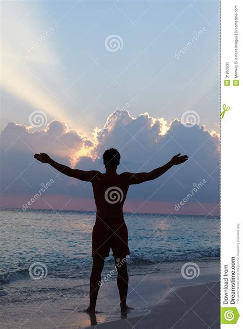 Silhouette Of Man With Outstretched Arms On Beach Stock Image Image