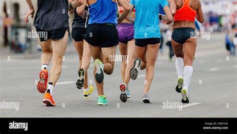 back legs group runners run marathon female and male athletes jogging city race sole running