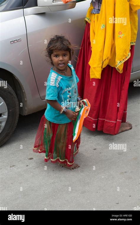 Poor Indian Girl Child Selling India Flags At A Traffic Stop Stock