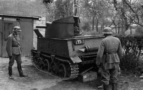 Abandoned Belgian Tank Is Inspected By Two German Soldiers 1940 800 ×