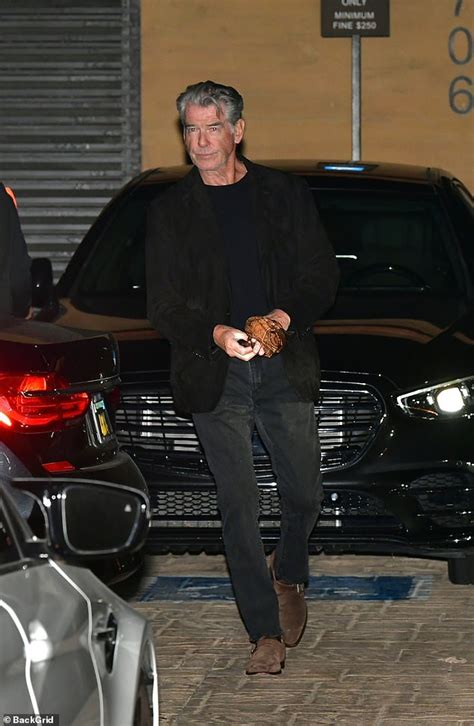 pierce brosnan cuts a dapper display in a black jacket and trousers as he enjoys a date night