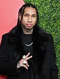 Tyga wearing an eye-catching black coat at the GQ Men of the Year party ...