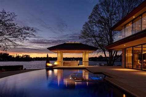 Sunset View Of Lakeside Backyard Featuring Modern Swimming