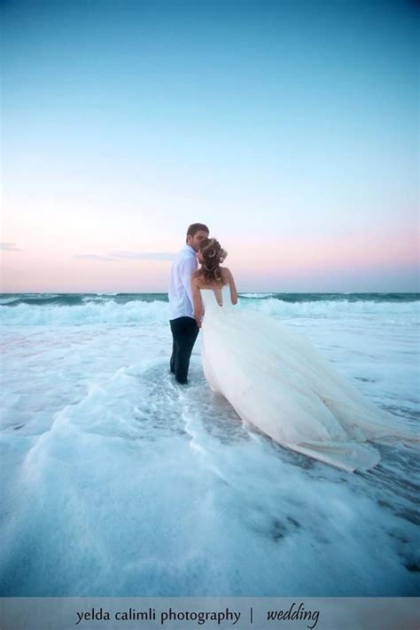 Go for a lower cost wedding dress. Gorgeous photo idea for a beach wedding...if you can stand ...