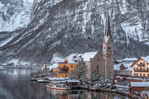 Snowy Village Hallstatt By Lake At Foot Of Snow Mountain With Clear Sky