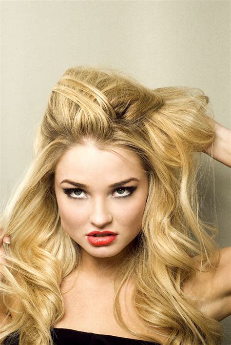A Woman With Long Blonde Hair And Red Lipstick On Her Face Posing For