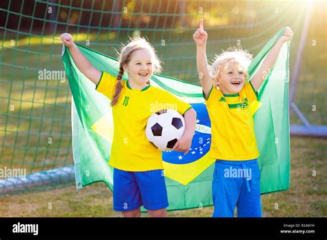 Kids Play Football On Outdoor Field Brazil Team Fans With National