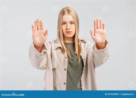 Portrait Of A Serious Girl Showing Stop Sign With Palms Stretch Out