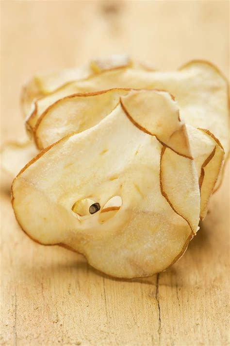 Dried Pear Slices On A Wooden Background Photograph By Eising Studio