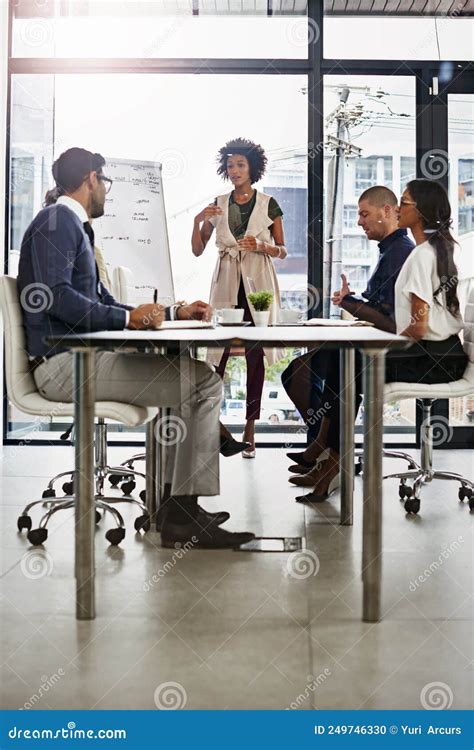 Let Me Try And Explain Shot Of Businesspeople In An Office Stock