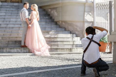 Wedding Photographer Takes Pictures Of Bride And Groom Stock Image