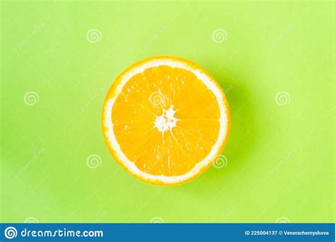 Top View Of One Orange Round Fruit On Bright Green Background Rich