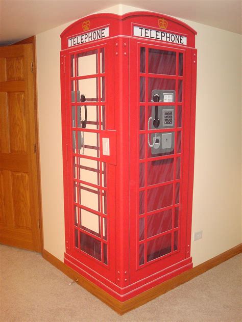 A Red Telephone Booth In The Corner Of A Room