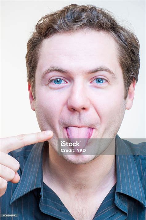 Portrait Of Man Points On His Tongue Human Face Parts Stock Photo