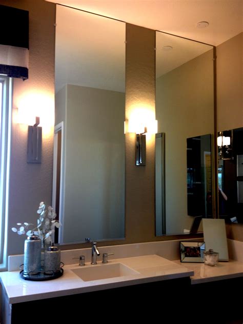 Counter To Ceiling High Mirrors And Wall Sconces In The Bathroom Create