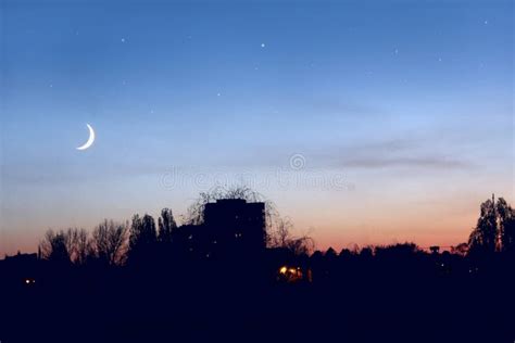 Evening Sky With Stars And Moon Above City Night Town Stock Photo